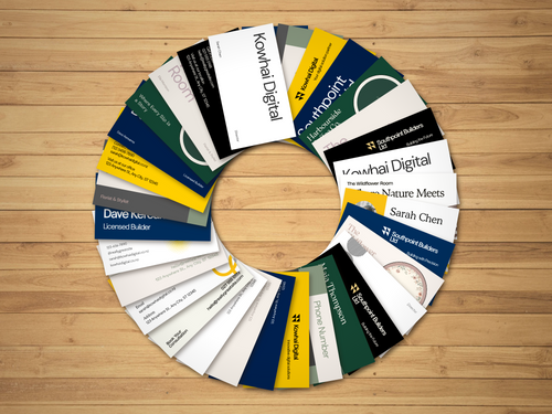 Range of custom business cards printed in NZ by Prep To Print — sample client designs fanned on a wooden desk