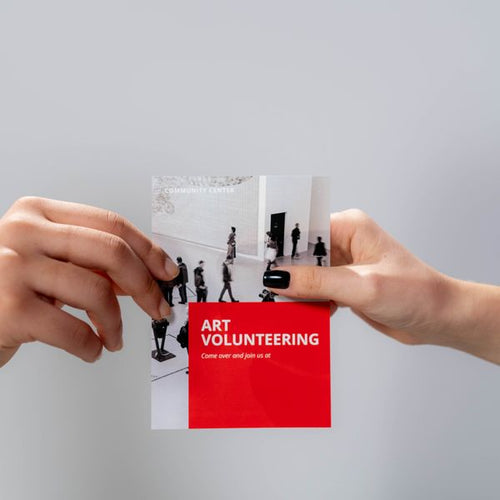 Hands holding a printed flyer — Prep To Print NZ
