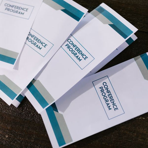 Folded brochures on a wooden surface — Prep To Print NZ
